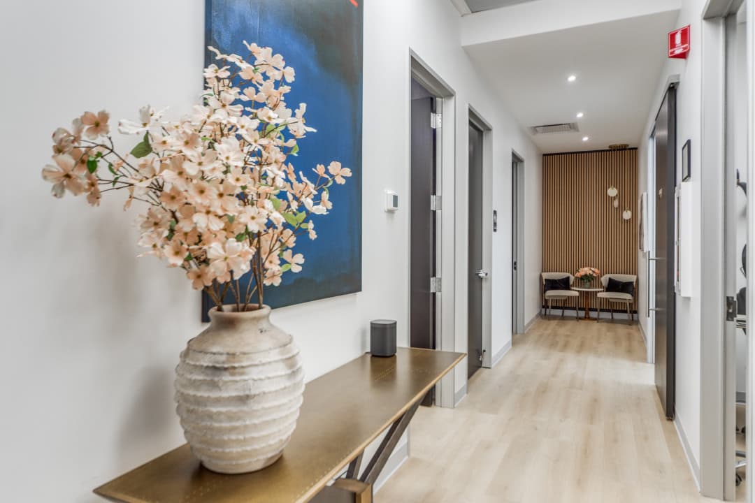 Office hallway with decorative flowers and seating area