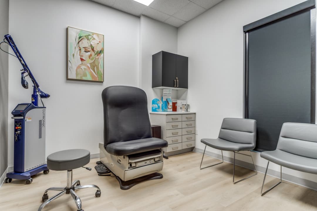 Treatment room with exam chair, laser device, and seating
