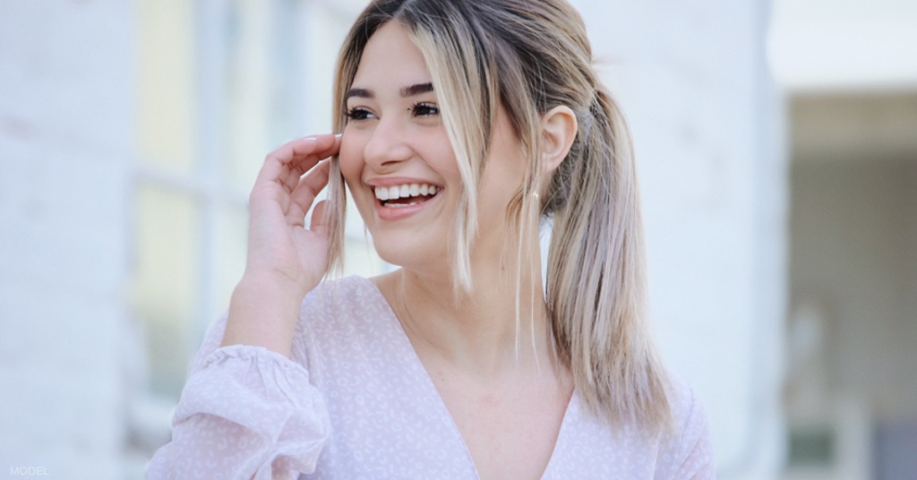 Young woman considering breast augmentation (model)