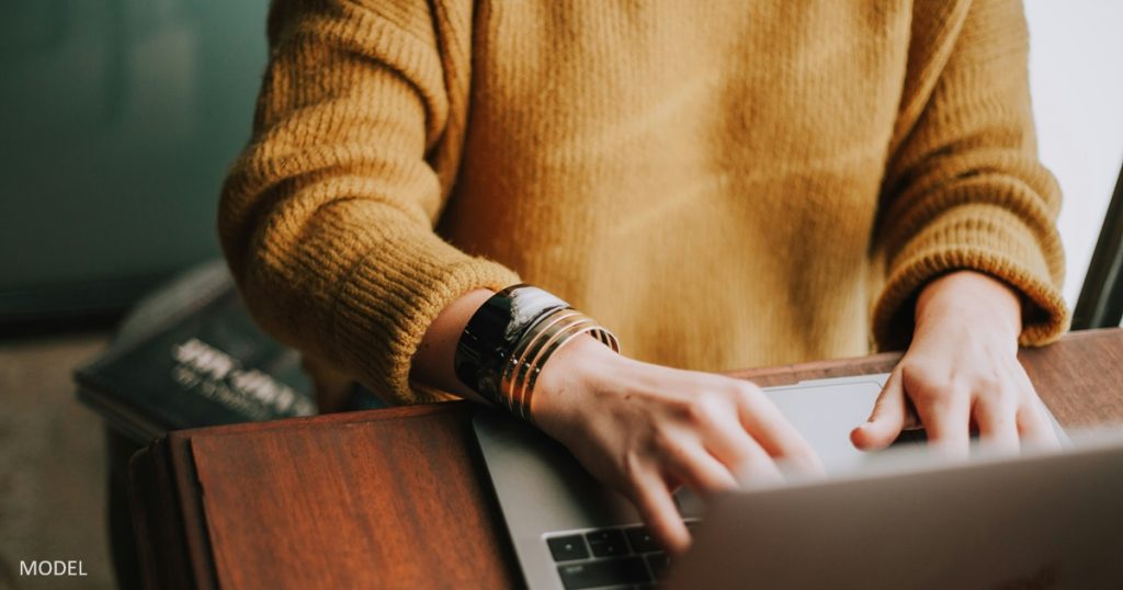 Woman researching plastic surgery procedures on her computer