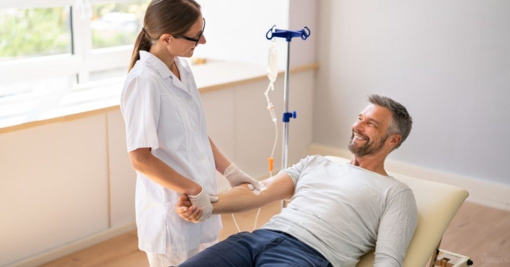 Patient receiving NAD+ IV therapy from a nurse. (Models)